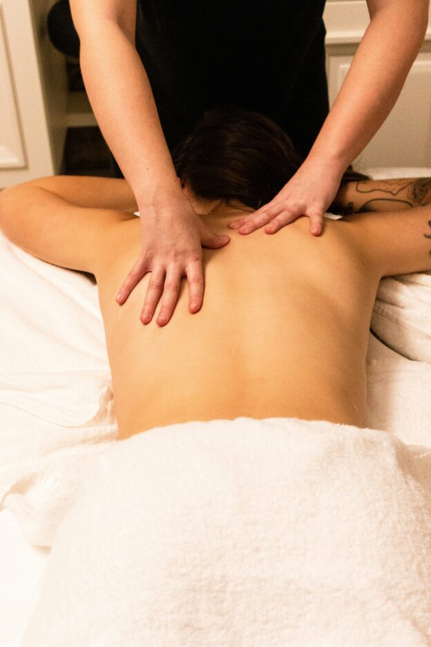 Massage therapy on upper back. Scapula. Sore muscles. Trapezius.